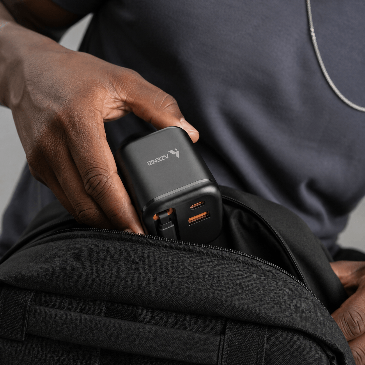 Compact Azenzi Plugd being placed inside a travel bag